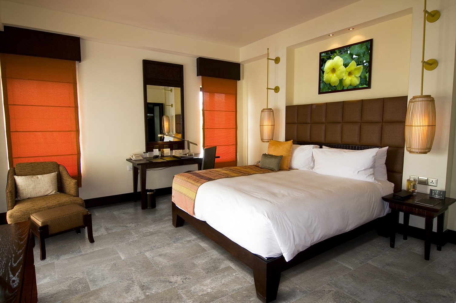 well-lit bedroom with a neatly made bed as the focal point